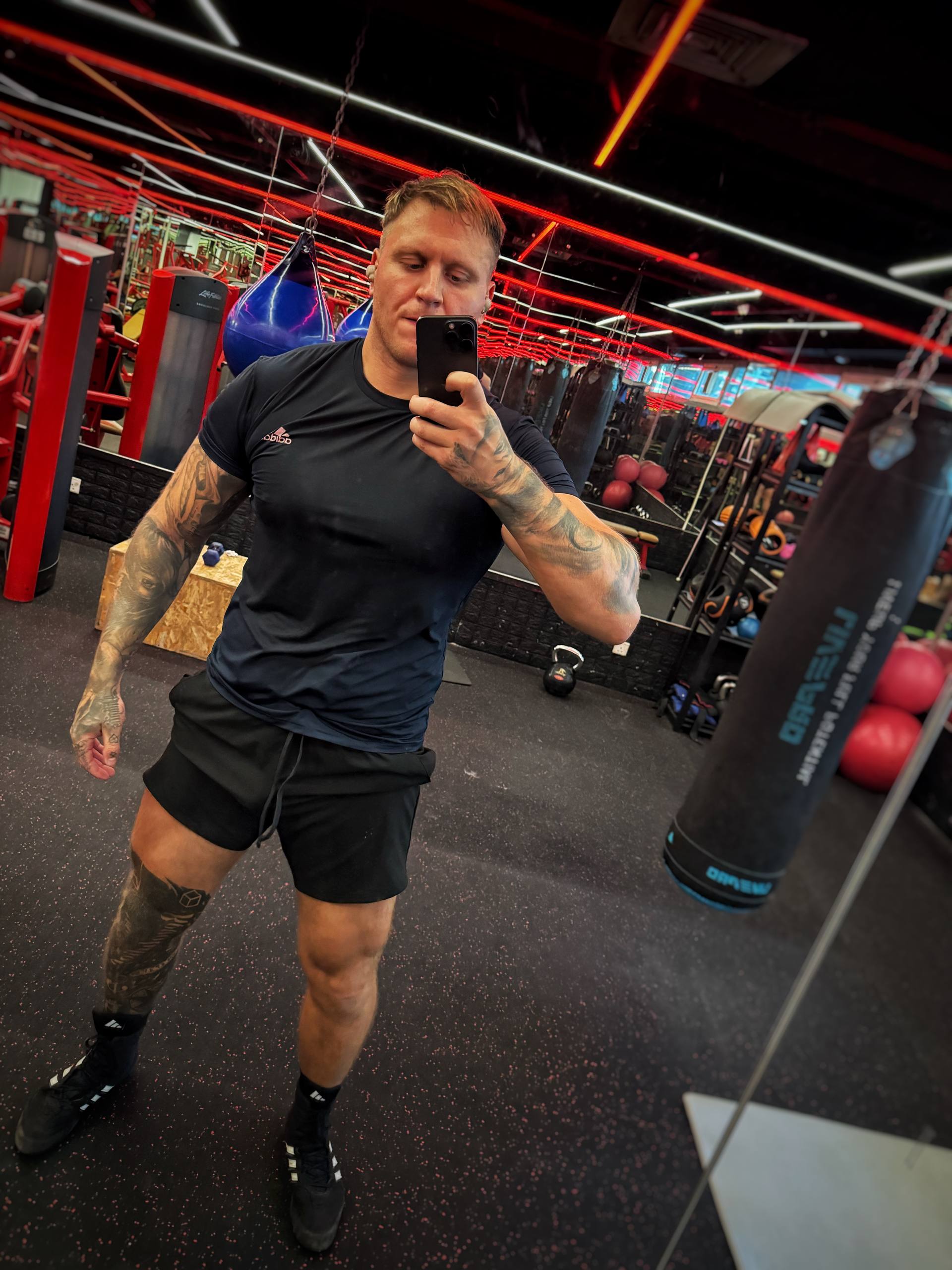 Coach demonstrating training environment and physique in Dubai gym